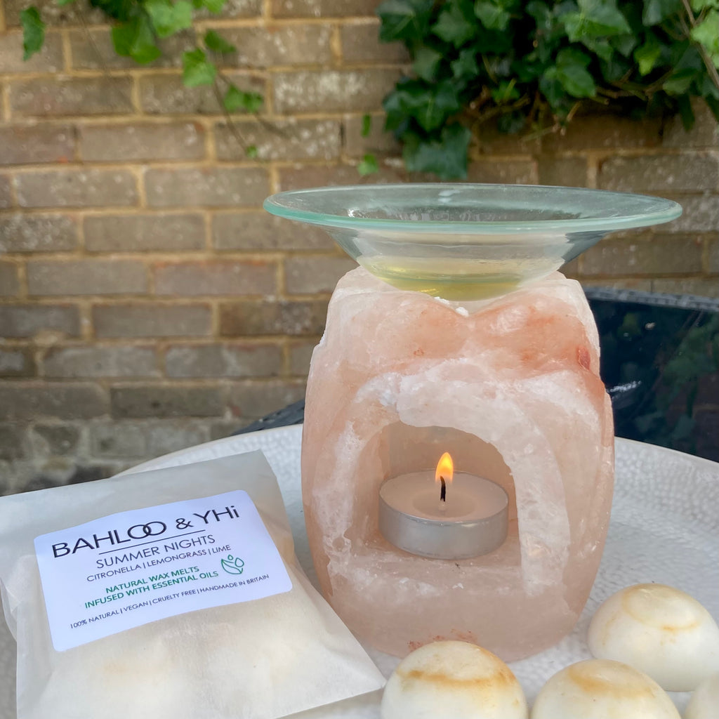 Citronella and lemongrass wax melts with himalayan salt wax burner. outdoors on garden table. BAHLOO & YHI Eastbourne
